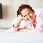 Portrait of beautiful middle aged woman lying in bed